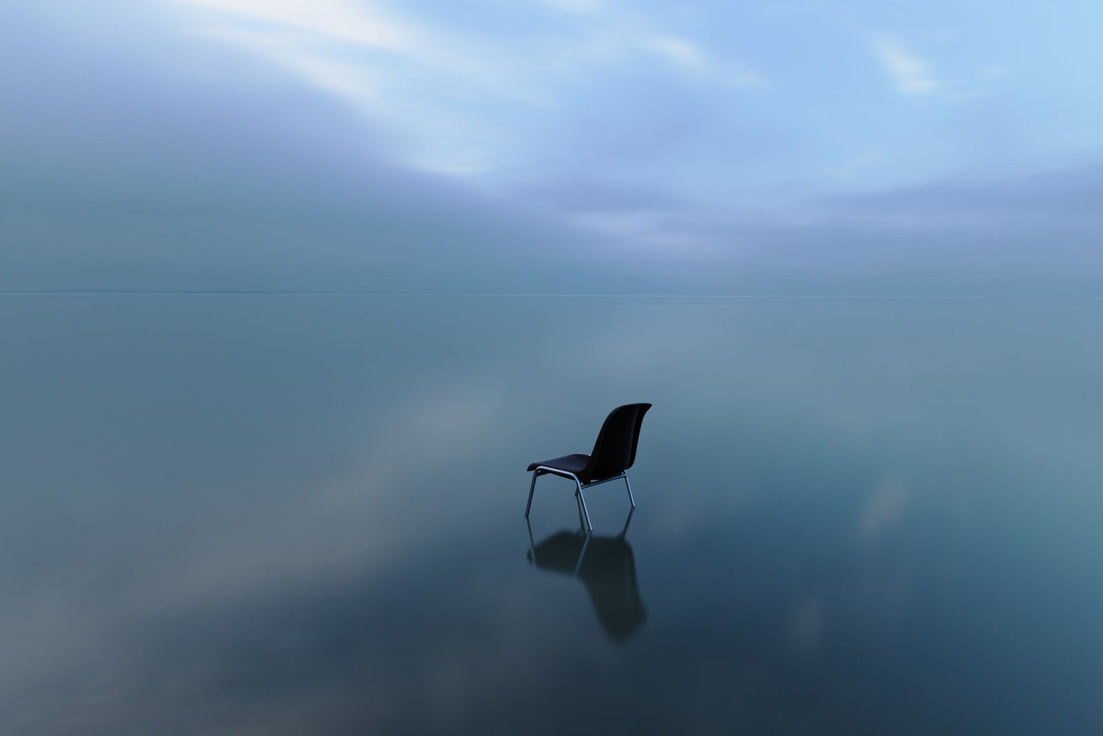 Single chair reflecting on a water surface on a stormy day